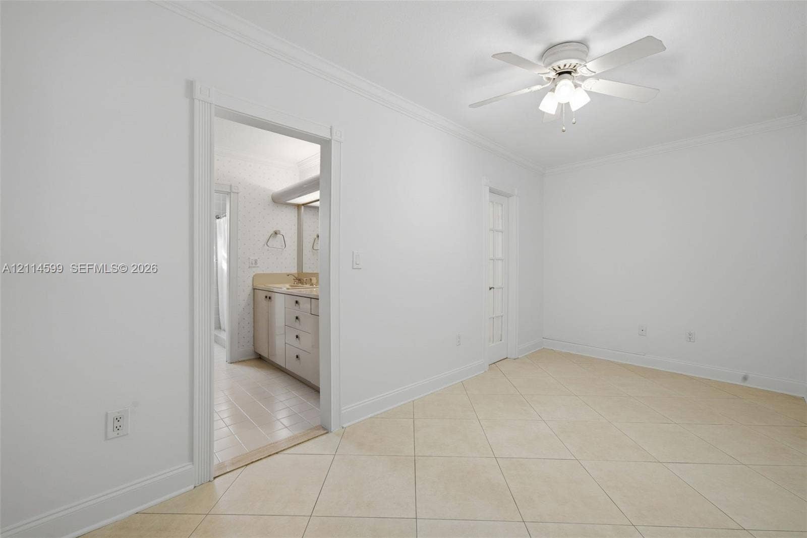 Room featuring ceramic tile flooring, crown molding, and a central ceiling fan with integrated lighting
