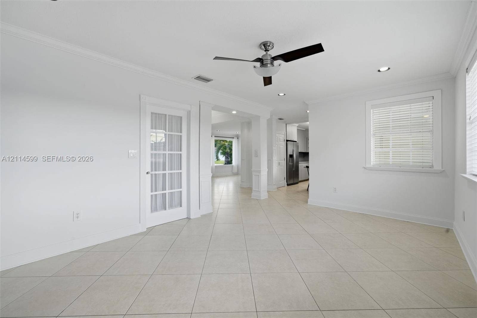 Ceramic tile flooring, recessed lighting, ceiling fan, and multi-pane glass door