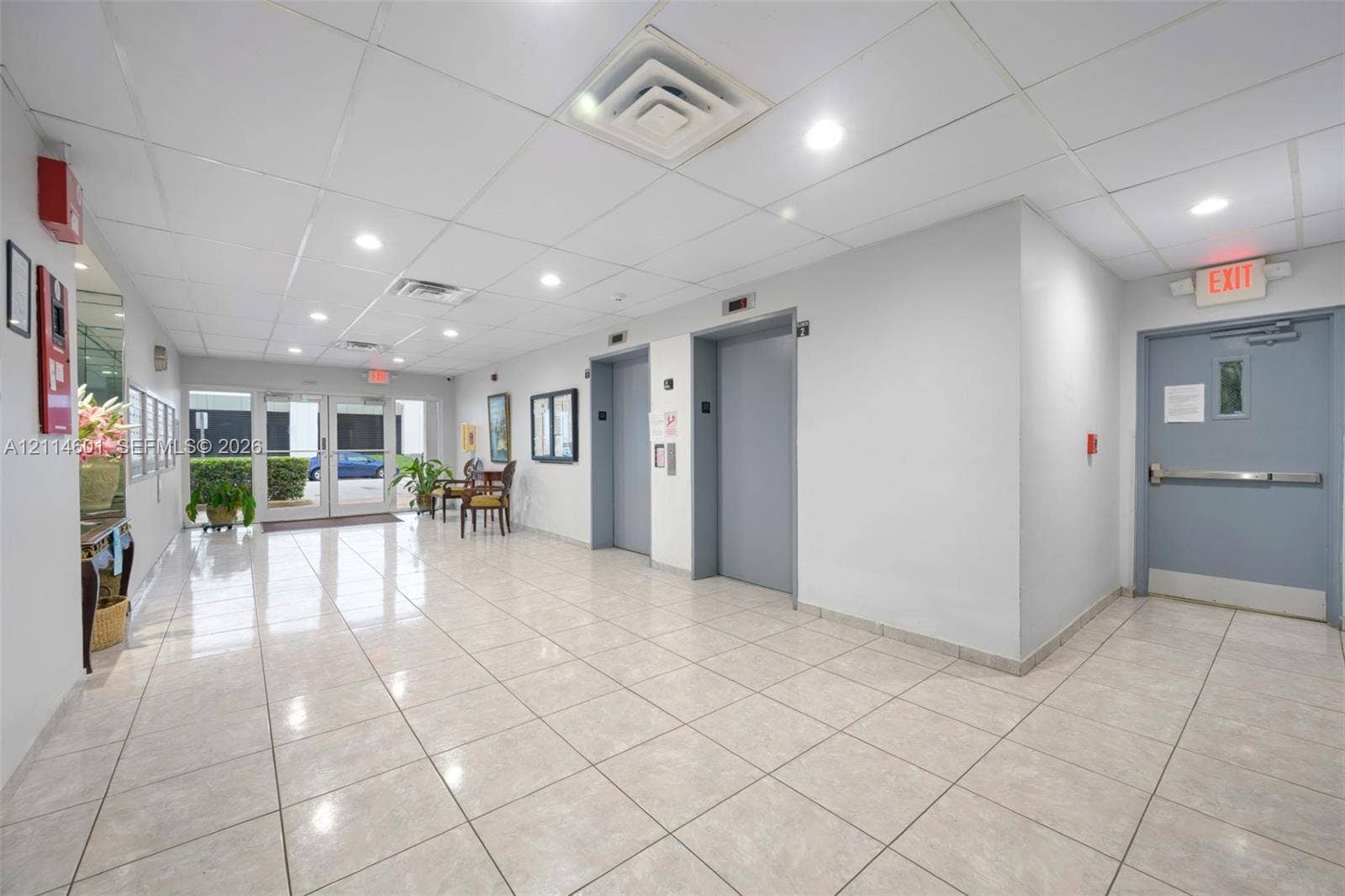 6801 Harding Avenue, #311, Miami Beach, Miami Beach, FL 33141 Common area lobby featuring tile flooring, recessed lighting, drop ceiling, and dual elevator access