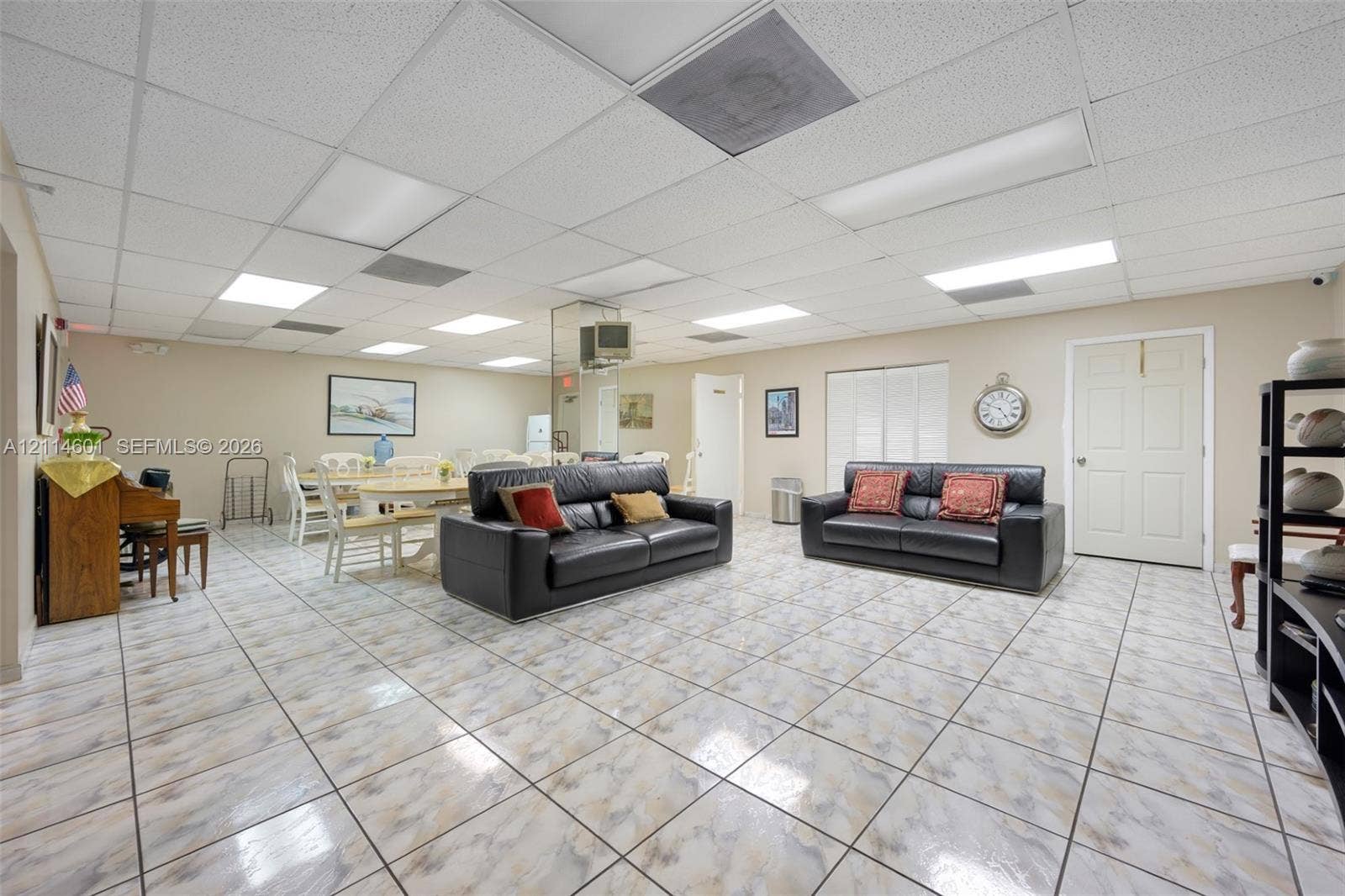 6801 Harding Avenue, #311, Miami Beach, Miami Beach, FL 33141 Large open-concept space featuring grid-pattern tile flooring, suspended drop ceiling, and inset panel lighting