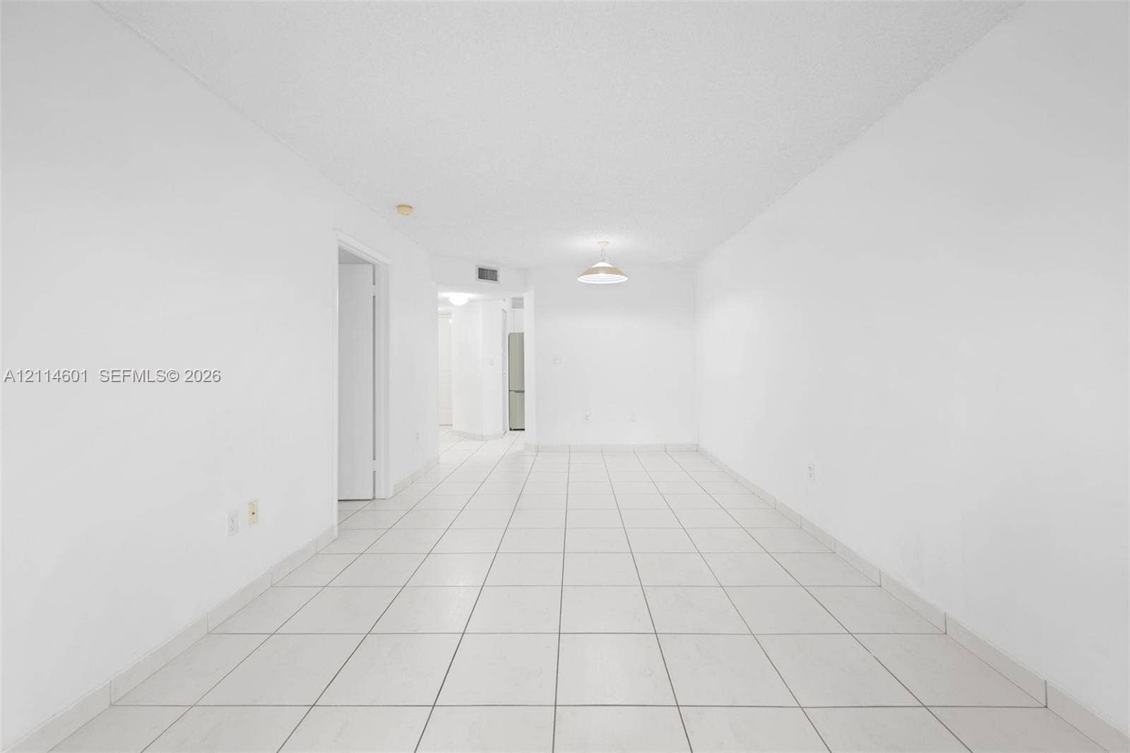 6801 Harding Avenue, #311, Miami Beach, Miami Beach, FL 33141 Interior area featuring white walls, neutral tile flooring, and a central pendant light fixture