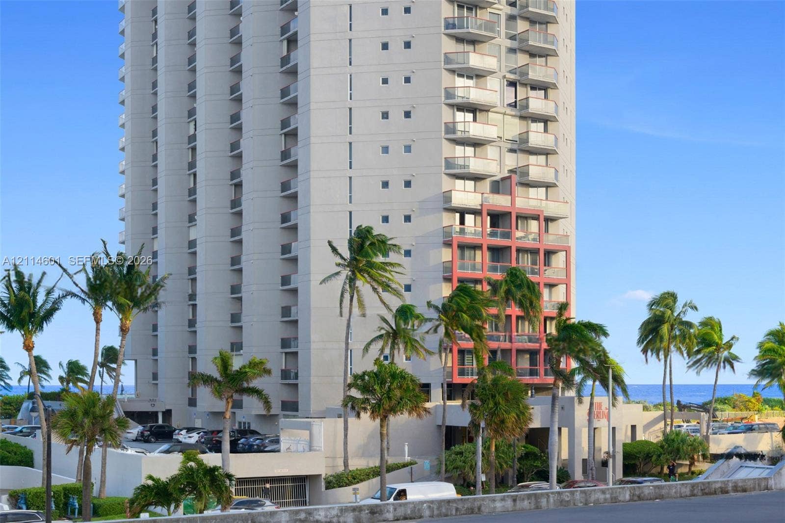 6801 Harding Avenue, #311, Miami Beach, Miami Beach, FL 33141 High-rise exterior featuring individual balconies, exterior accent detailing, a covered entrance, and mature palm trees