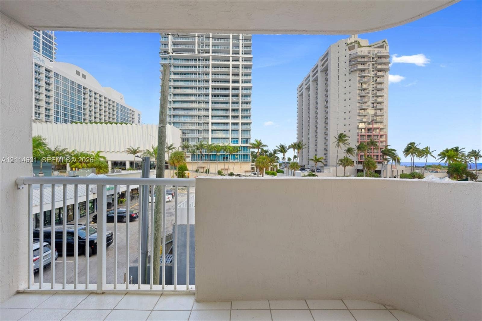 6801 Harding Avenue, #311, Miami Beach, Miami Beach, FL 33141 Private balcony featuring tiled flooring, a solid concrete perimeter wall, and a white metal safety railing