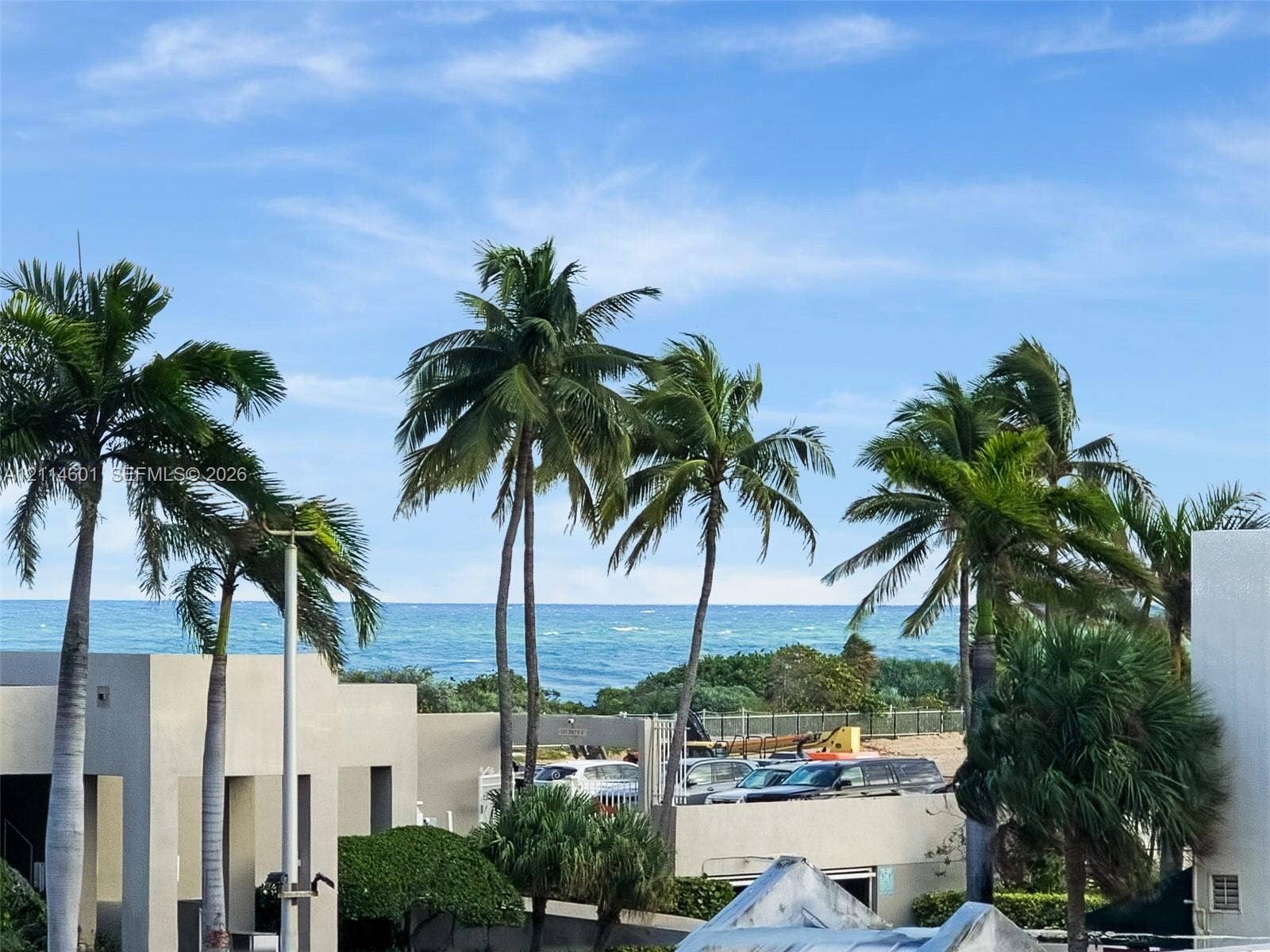6801 Harding Avenue, #311, Miami Beach, Miami Beach, FL 33141 Oceanfront exterior featuring mature palm trees, concrete architectural elements, and proximity to the coastline
