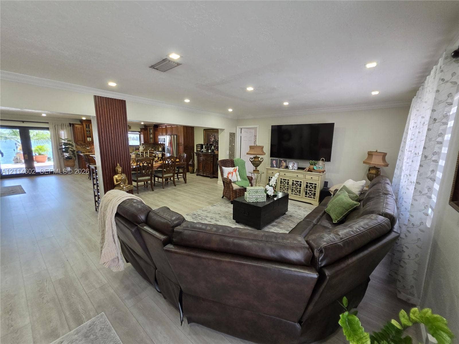 8450 NW 178th Street, Hialeah, Hialeah, FL 33015 Open concept floor plan featuring recessed lighting, wood-finish flooring, decorative vertical pillar detailing, and double French doors