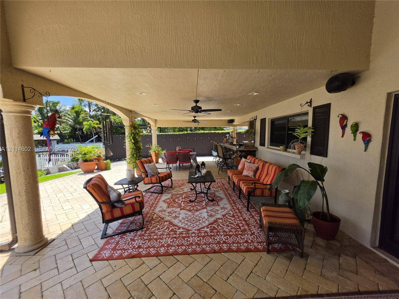 8450 NW 178th Street, Hialeah, Hialeah, FL 33015 Covered patio featuring herringbone-pattern paver flooring, recessed lighting, ceiling fans, and an arched architectural column