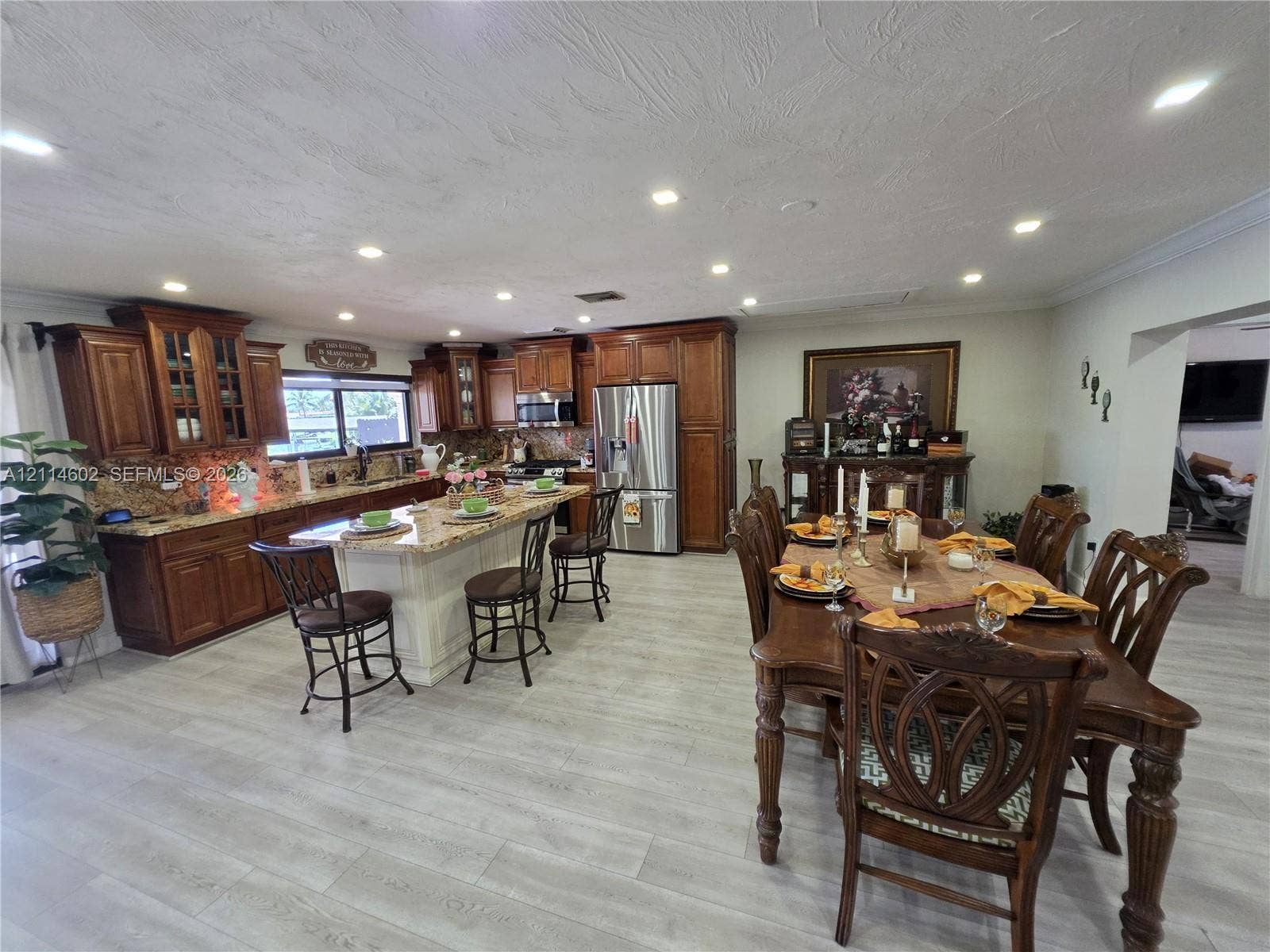 8450 NW 178th Street, Hialeah, Hialeah, FL 33015 Kitchen featuring stained wood cabinetry, stone countertops, a central island, recessed lighting, and wood-finish flooring