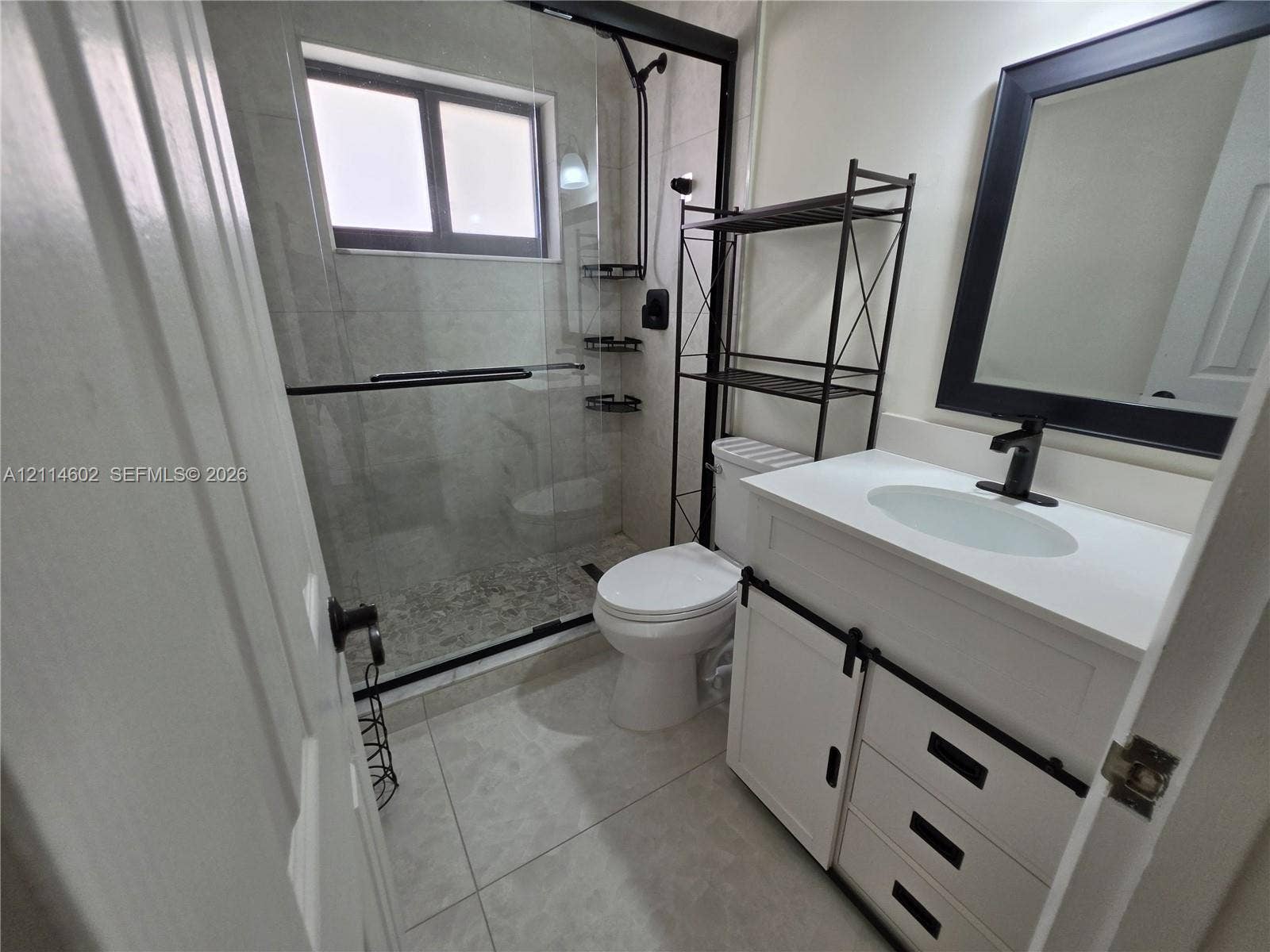 8450 NW 178th Street, Hialeah, Hialeah, FL 33015 White vanity with a rectangular sink, matte black hardware, and an integrated countertop