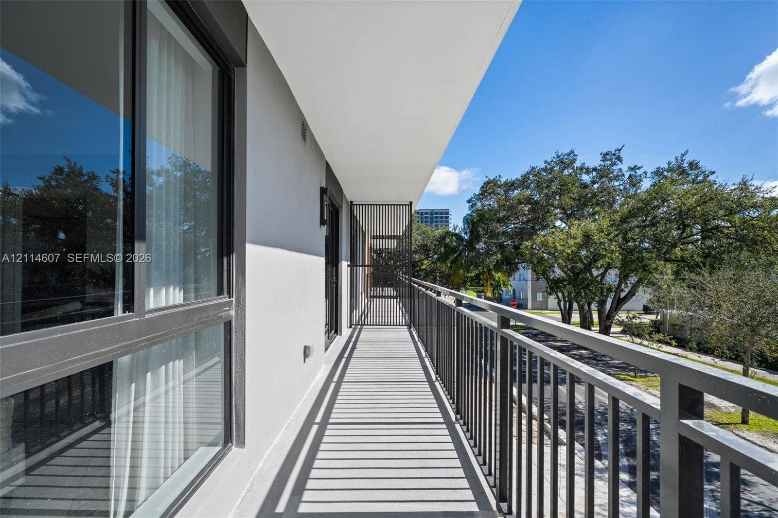 2479 NE 192nd Street, #103, Miami, Miami, FL 33180 Private balcony featuring metal railing, vertical privacy screen, and neutral concrete flooring
