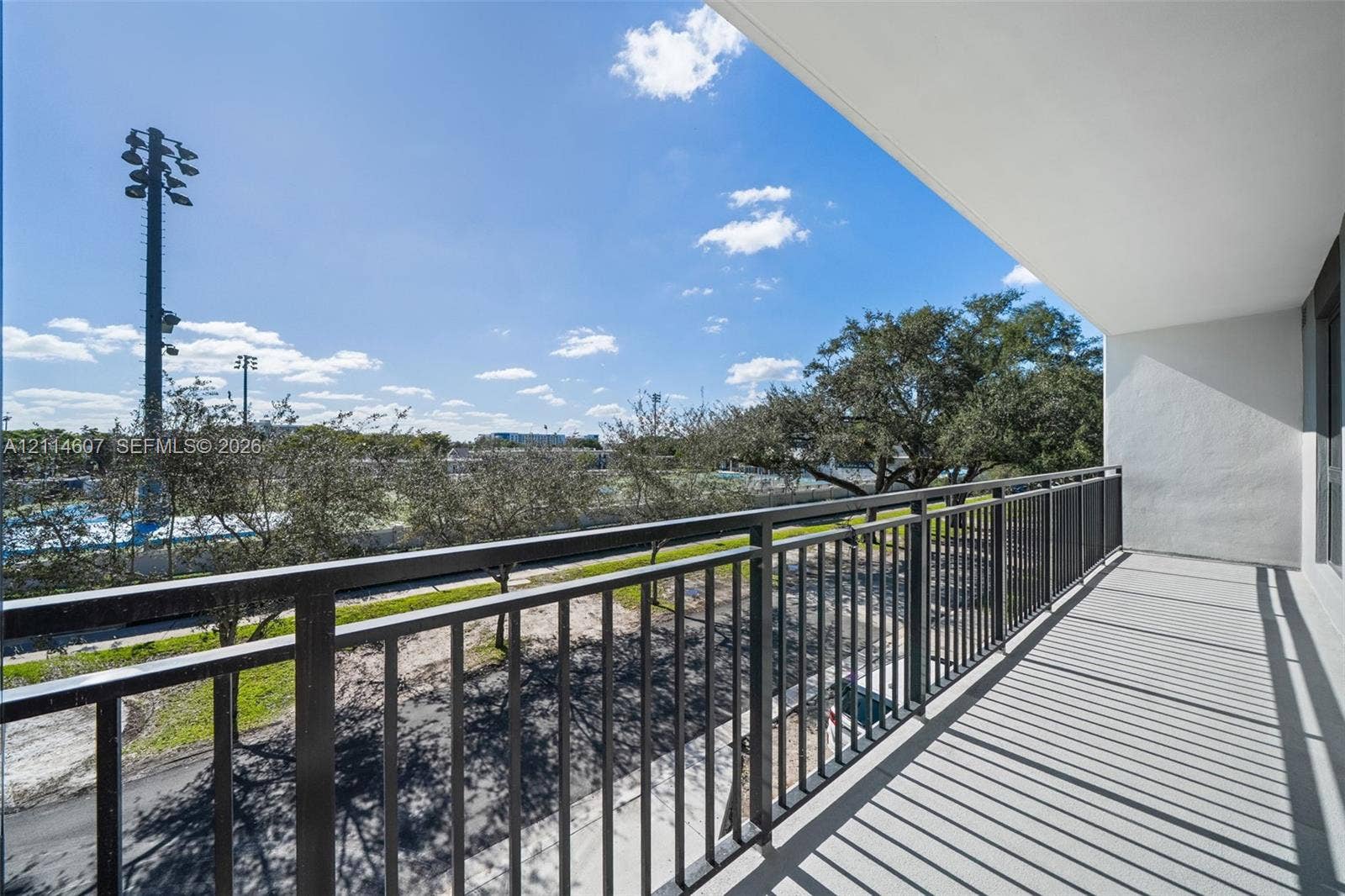 2479 NE 192nd Street, #103, Miami, Miami, FL 33180 Covered balcony with black metal railings and concrete flooring