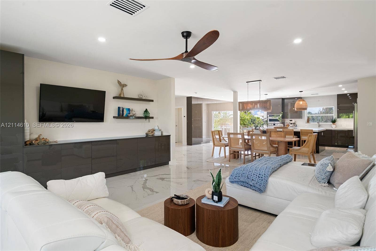 131 Ojibway Avenue, Islamorada, FL 33070 High-gloss cabinetry, large-format stone-finish flooring, recessed lighting, sculptural ceiling fan, and floating wall shelves