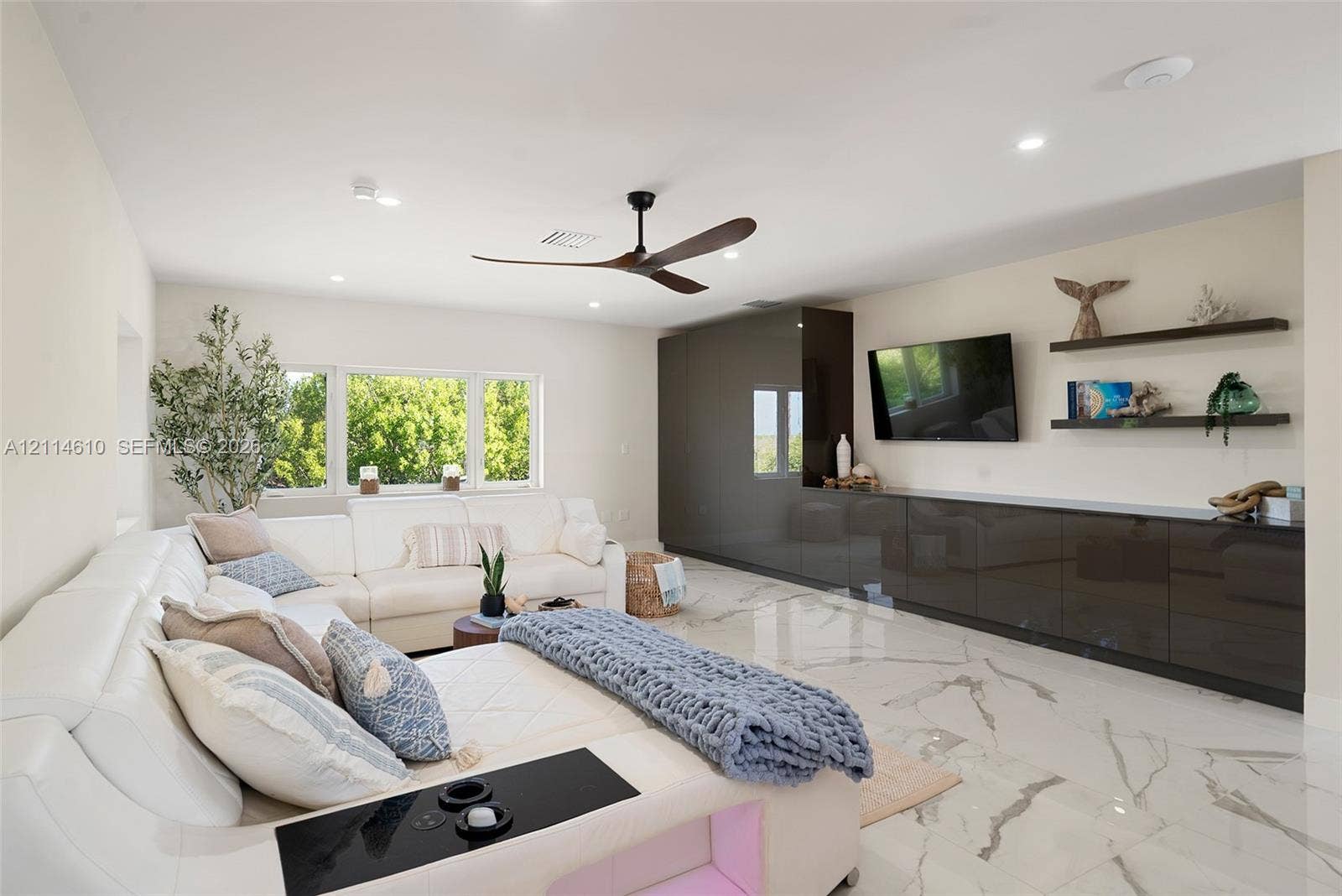 131 Ojibway Avenue, Islamorada, FL 33070 Large-format tile flooring, high-gloss built-in cabinetry, recessed lighting, multi-blade ceiling fan, and floating wall shelves