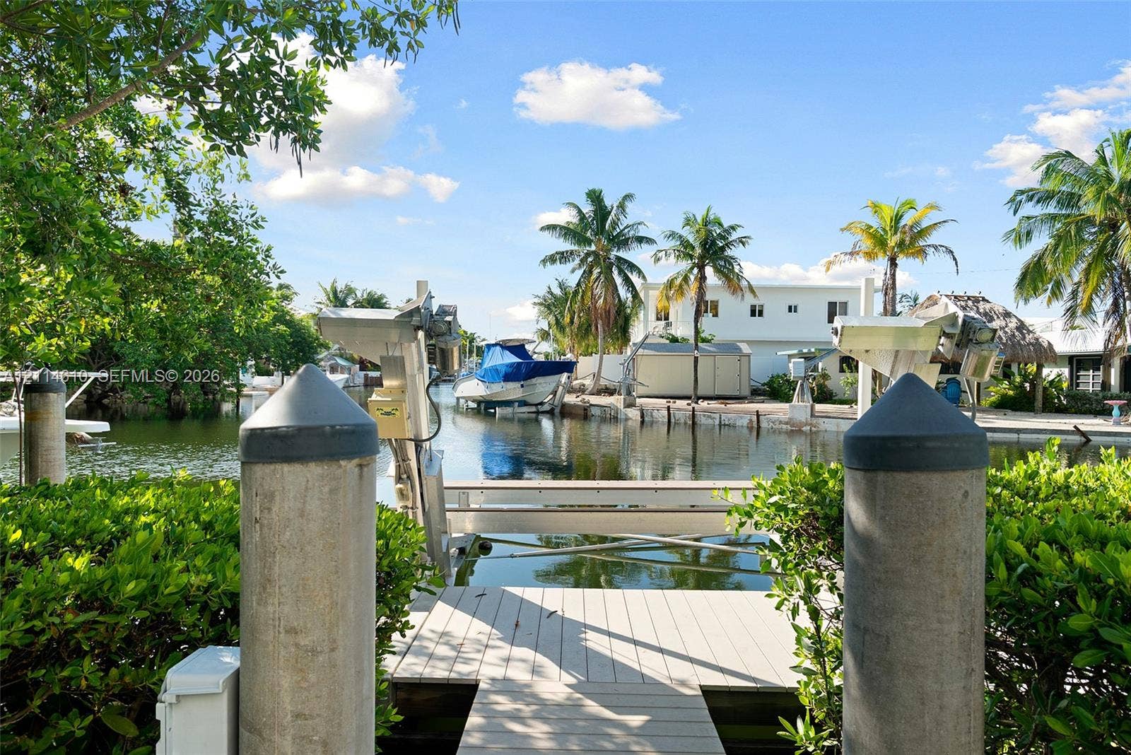131 Ojibway Avenue, Islamorada, FL 33070 Waterfront dock featuring composite decking, reinforced concrete pilings, and an integrated boat lift system