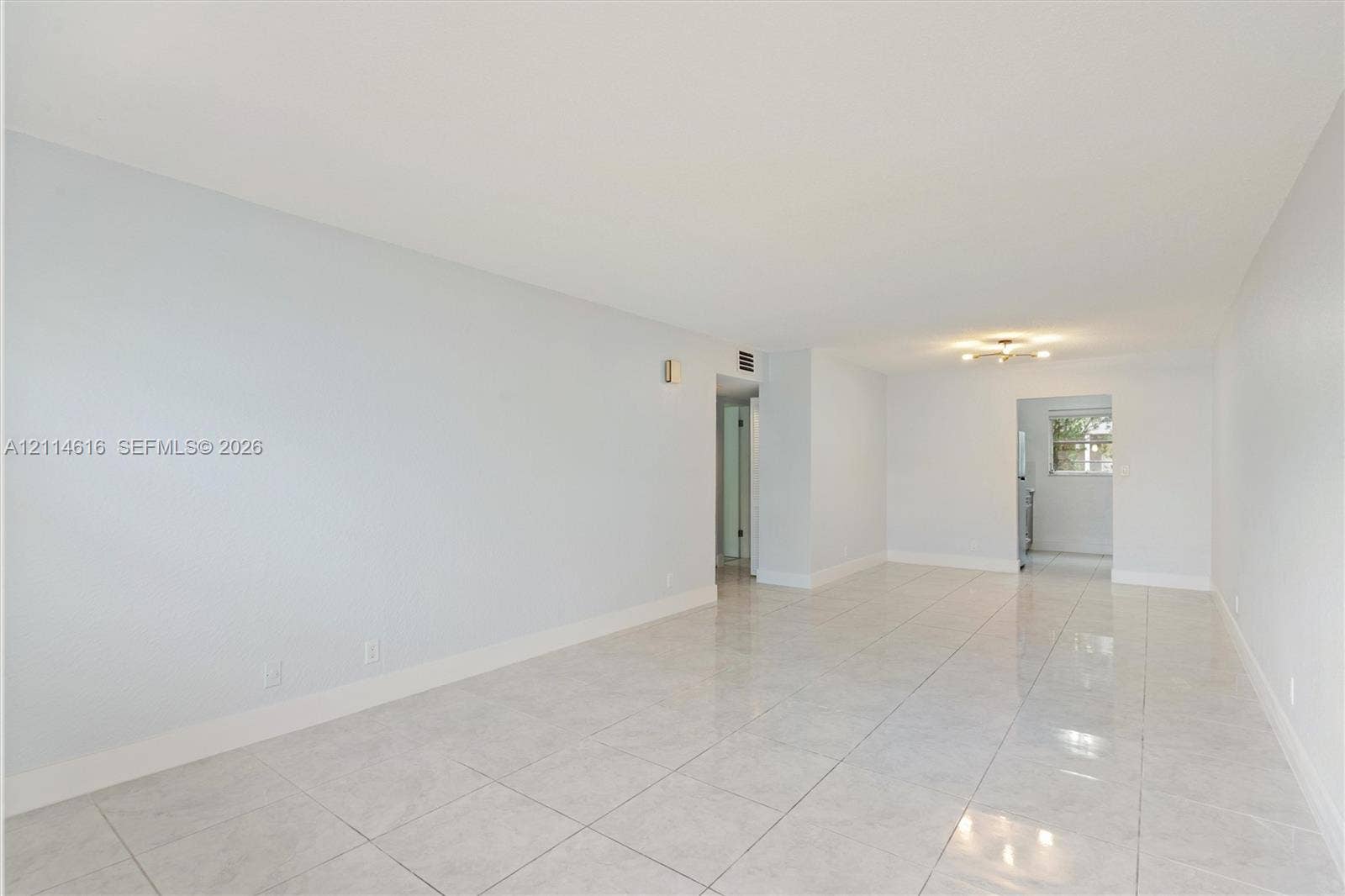 2607 NE 8th Avenue, #35, Wilton Manors, FL 33334 Neutral-toned interior featuring large-format tile flooring and a ceiling-mounted light fixture