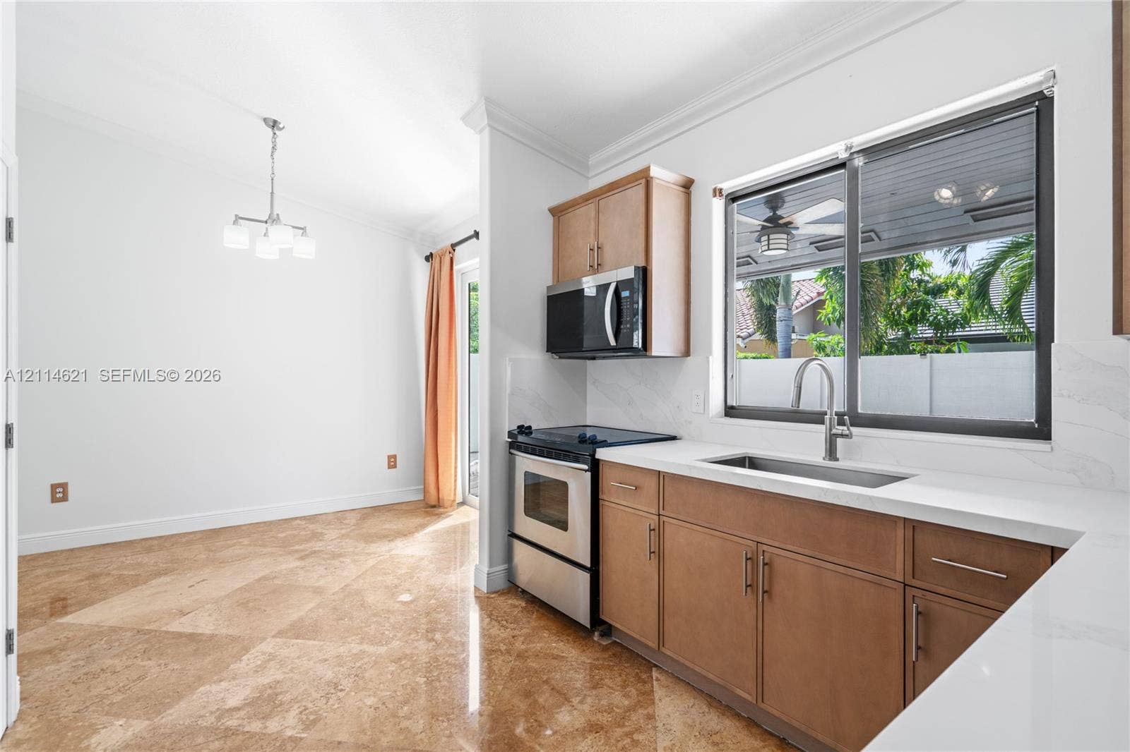8978 NW 152nd Lane, #8978, Miami Lakes, Miami Lakes, FL 33018 Kitchen featuring stone tile flooring, flat-panel wood cabinetry, quartz countertops, stainless steel appliances, and a stainless steel undermount sink with a gooseneck faucet