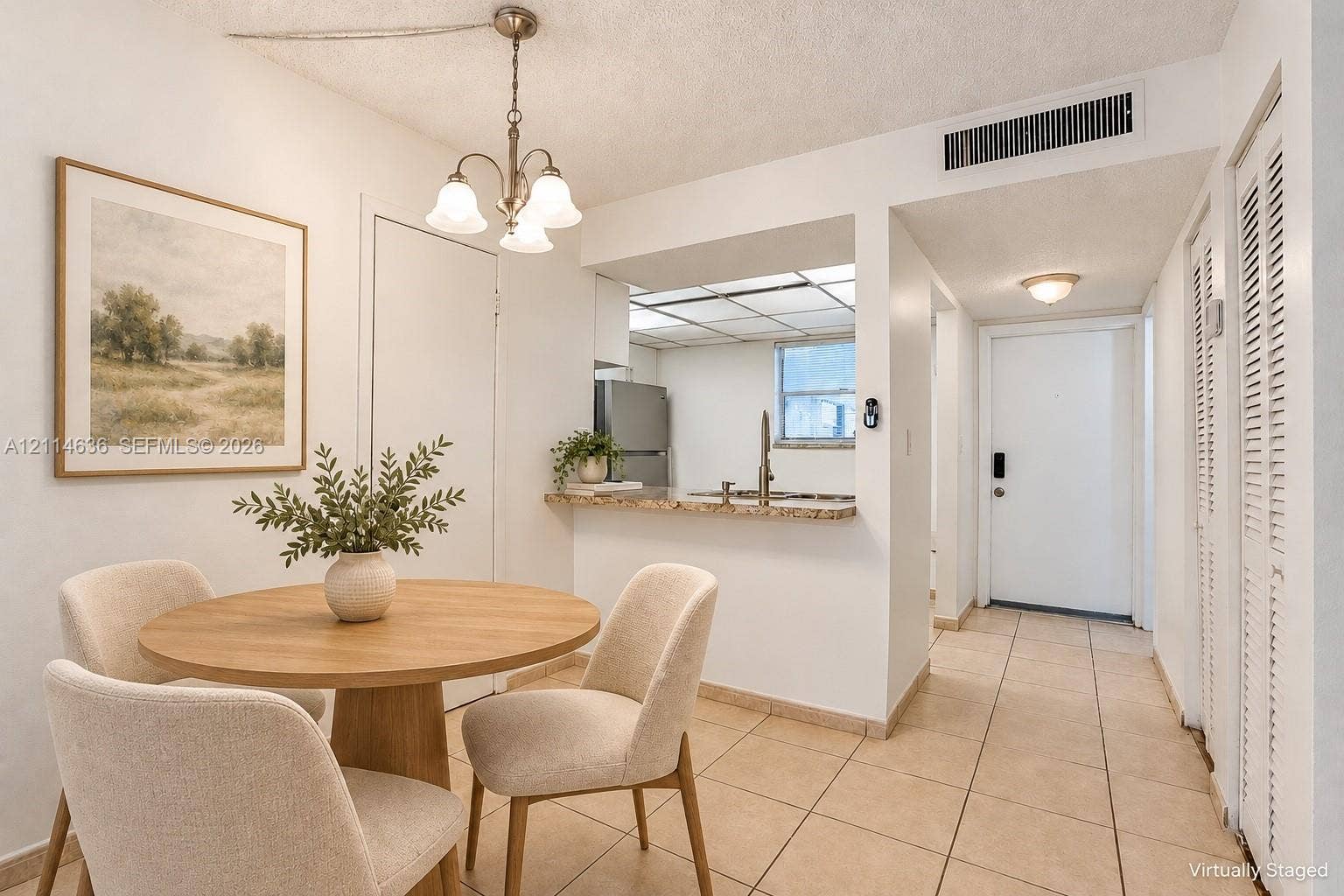 14155 SW 87th Street, #404-E, Miami, Miami, FL 33183 Kitchen area featuring a stone-surface breakfast bar, ceramic tile flooring, a suspended three-light chandelier, and louvered-door closets