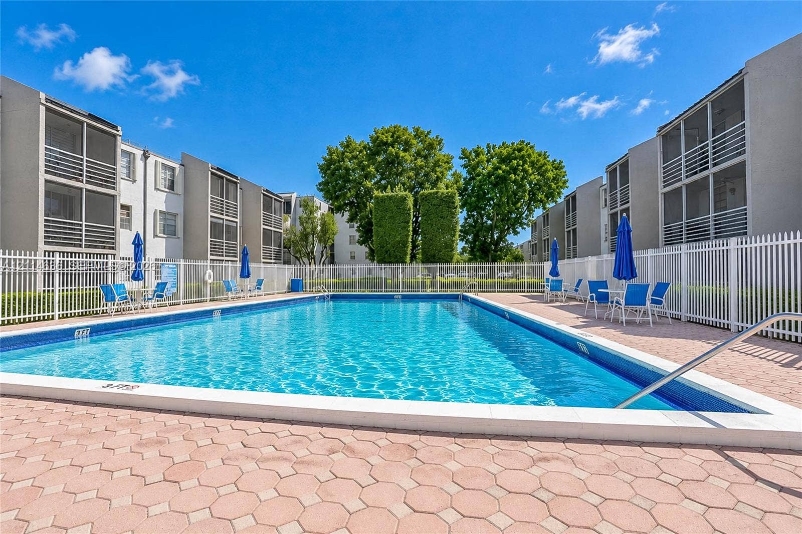14155 SW 87th Street, #404-E, Miami, Miami, FL 33183 Outdoor swimming pool featuring a concrete paver deck and white perimeter fencing