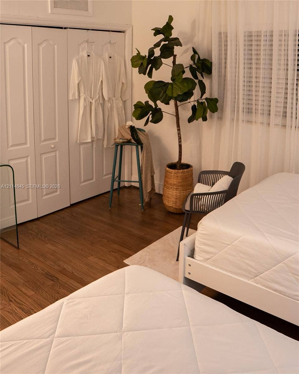Wood-finish flooring, multi-panel closet doors, and window treatments