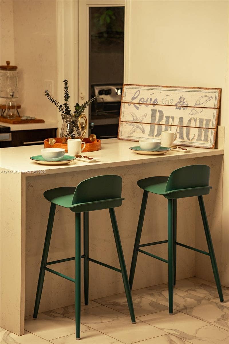 Countertop with waterfall edge, integrated flat-surface finish, and tile flooring