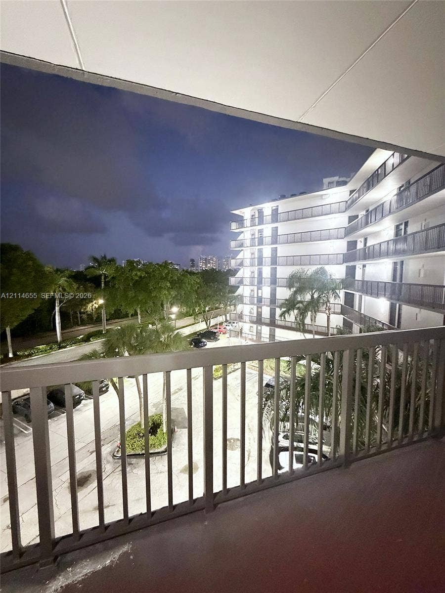 3301 N Country Club Drive, #507, Aventura, Aventura, FL 33180 Laundry room featuring multiple white front-loading clothes washers and dryers, a stainless steel folding table, and solid-surface flooring