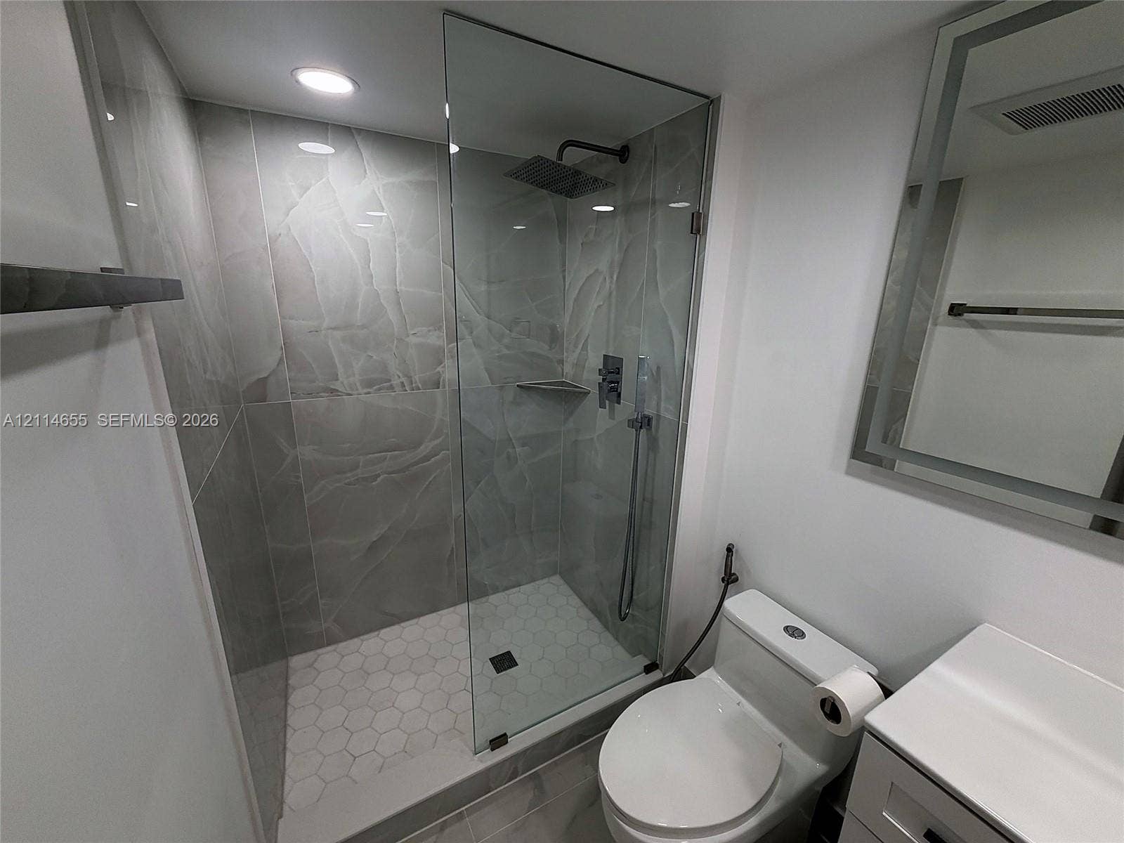 3301 N Country Club Drive, #507, Aventura, Aventura, FL 33180 Exterior perspective featuring a multi-story building, dedicated surface parking, mature palm trees, and established landscaping