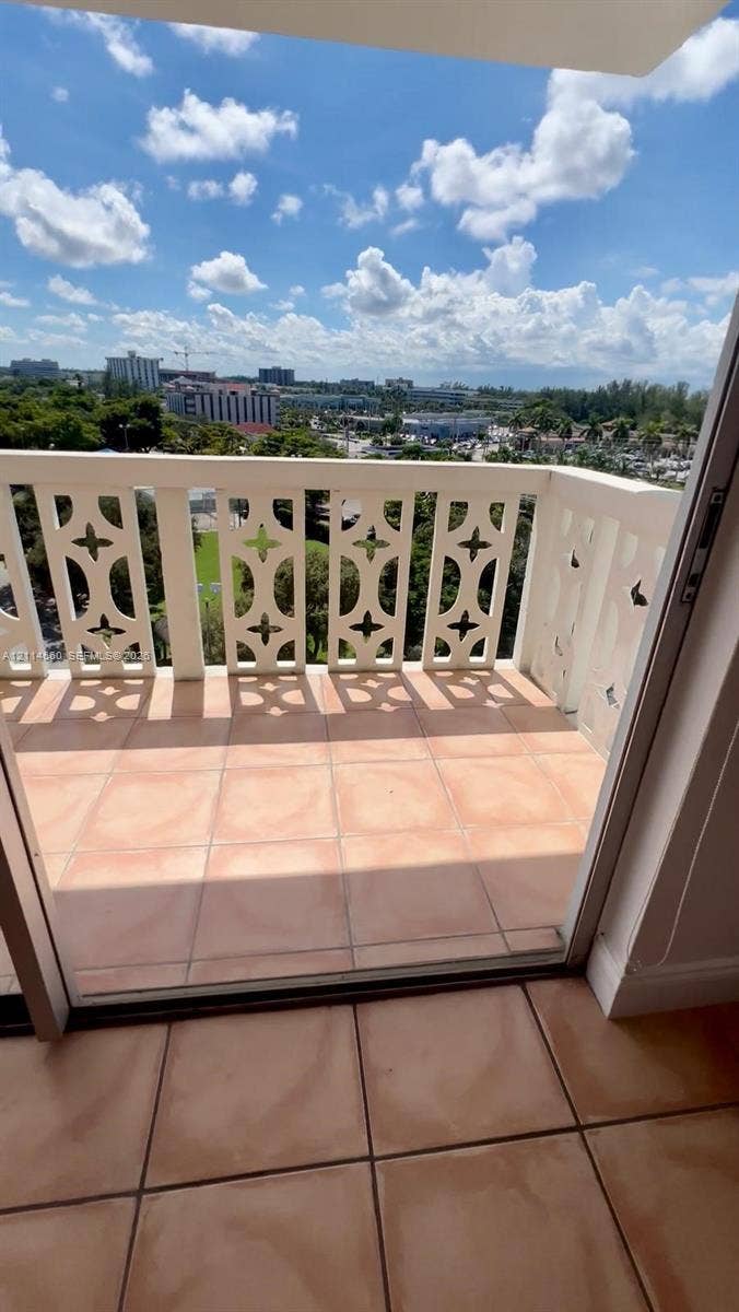 Private balcony featuring decorative geometric railing and tile flooring