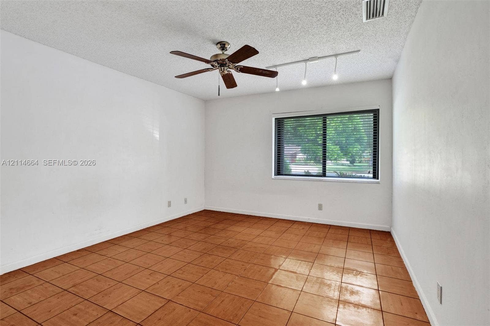 11164 NW 10th Place, Coral Springs, FL 33071 Room featuring large-format ceramic tile flooring, a multi-blade ceiling fan, and adjustable track lighting
