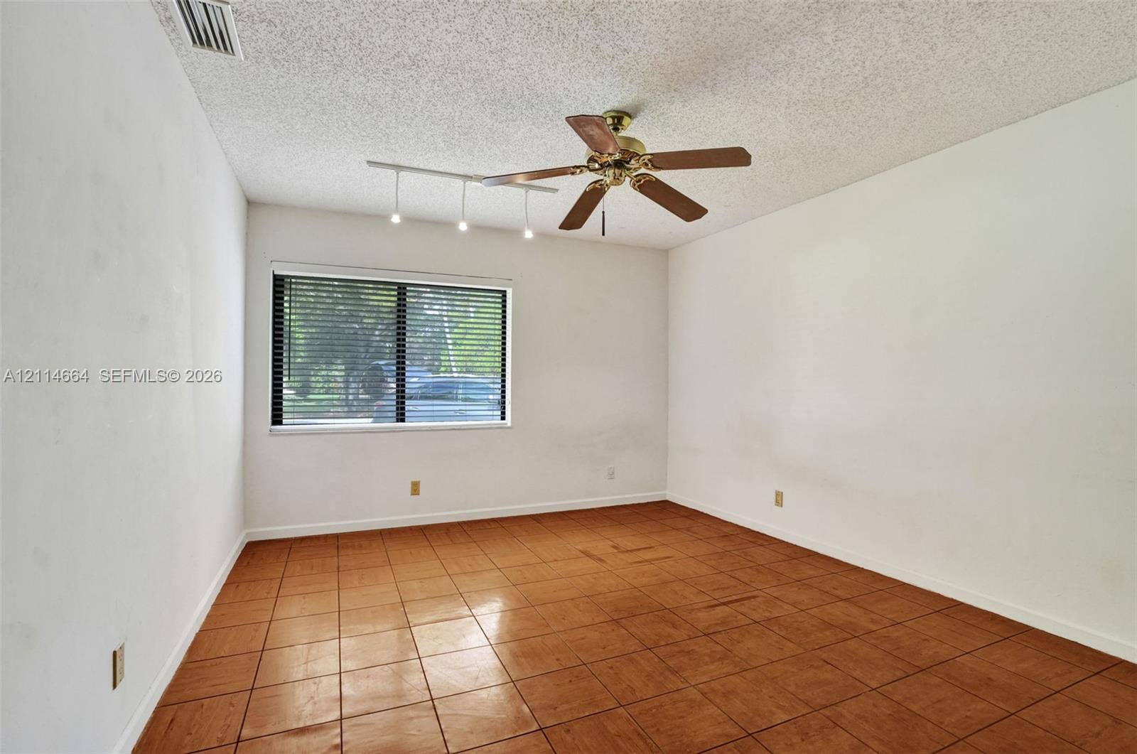 11164 NW 10th Place, Coral Springs, FL 33071 Room featuring tile flooring, ceiling fan with integrated light fixture, and track lighting