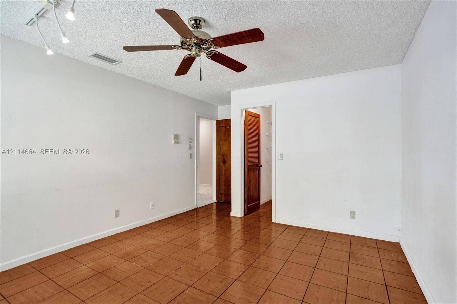 11164 NW 10th Place, Coral Springs, FL 33071 Room featuring ceramic tile flooring, a central ceiling fan with integrated lighting, and a multi-directional track lighting fixture