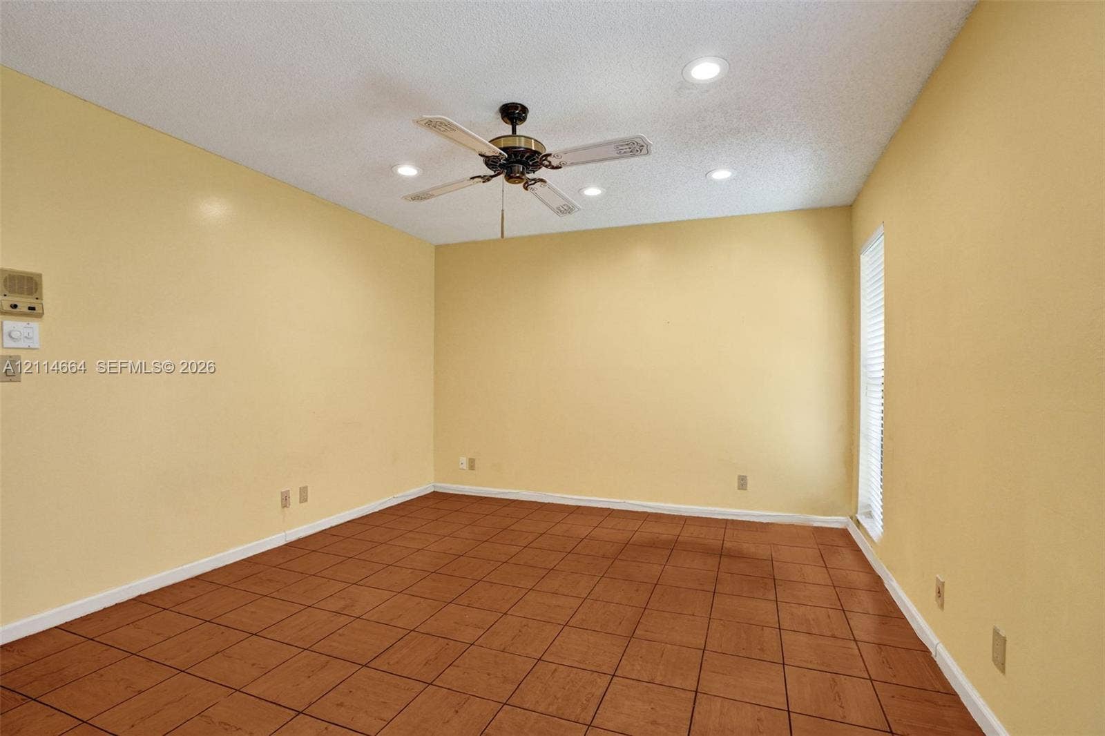 11164 NW 10th Place, Coral Springs, FL 33071 Interior room featuring tile flooring, a central ceiling fan with integrated lighting, and recessed ceiling lights