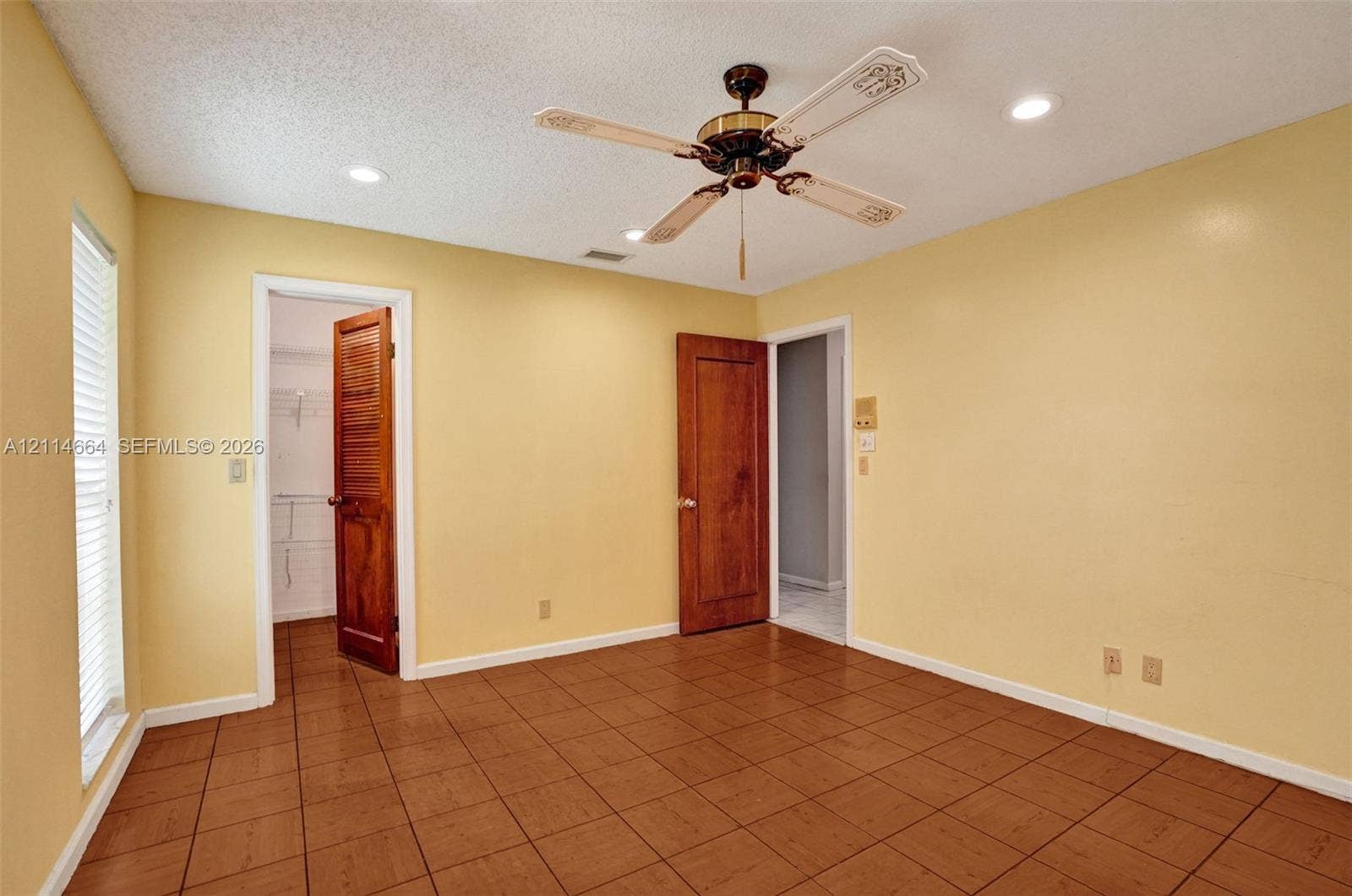 11164 NW 10th Place, Coral Springs, FL 33071 Interior space featuring ceramic tile flooring, recessed lighting, a ceiling fan, and solid wood-finish doors