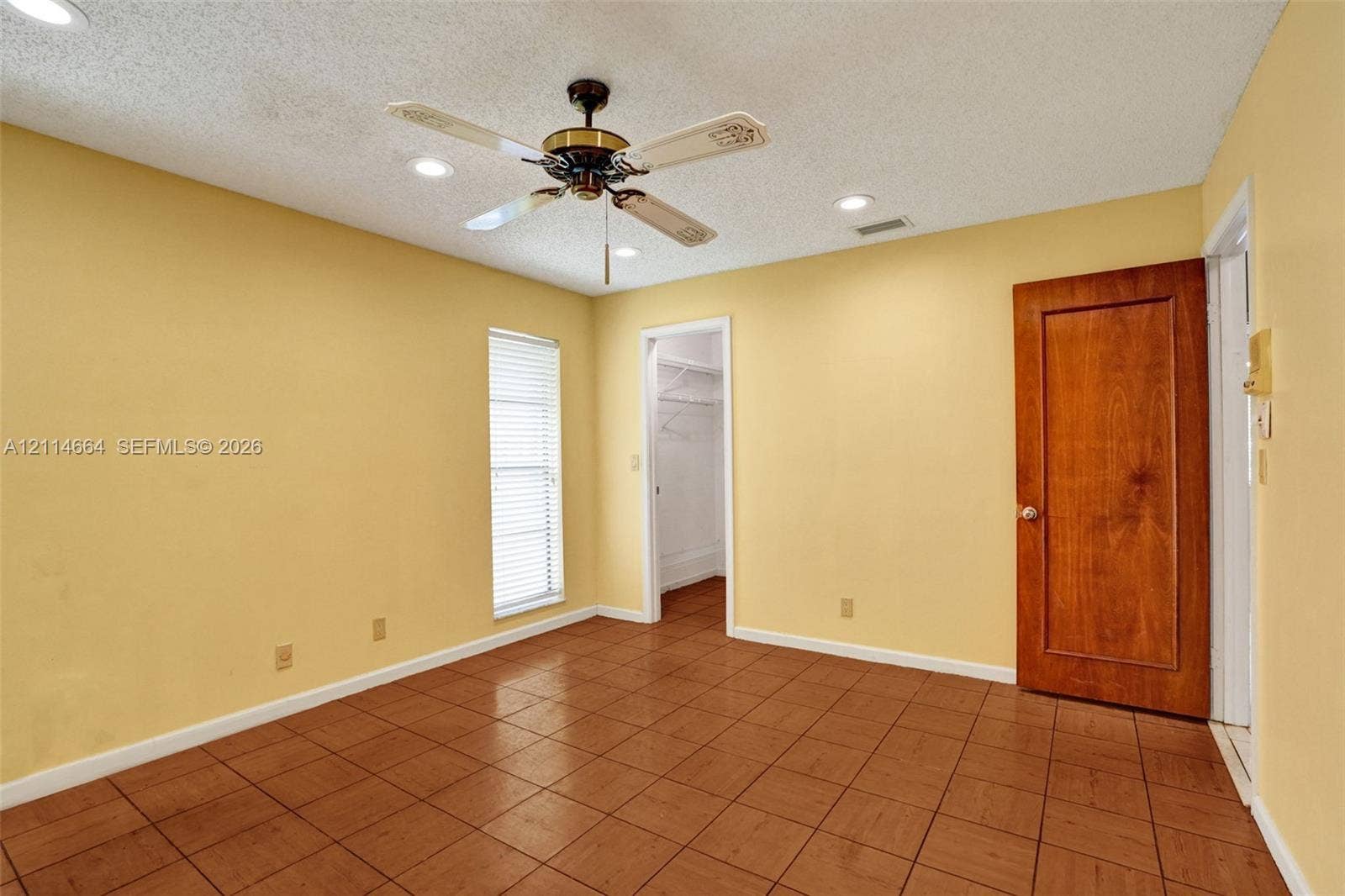 11164 NW 10th Place, Coral Springs, FL 33071 Interior space featuring tile flooring, ceiling fan with light fixture, recessed lighting, and a solid wood door