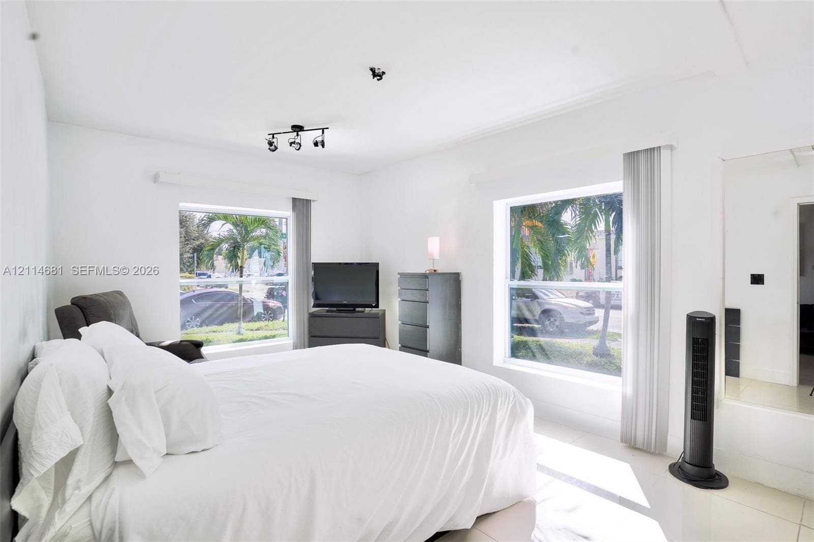 6700 NW 5th Avenue, Miami, FL 33150 Neutral interior featuring large windows with natural light, tiled flooring, track lighting, and a mirrored wall panel