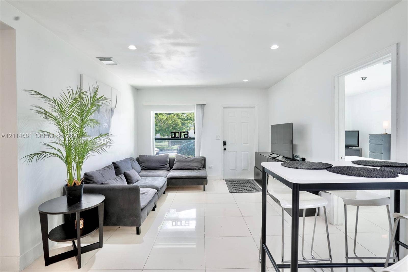 6700 NW 5th Avenue, Miami, FL 33150 Open-concept interior featuring large-format tile flooring, recessed ceiling lighting, and natural light from a rectangular window