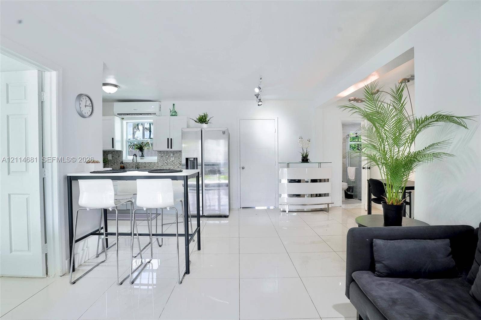 6700 NW 5th Avenue, Miami, FL 33150 Kitchen featuring white cabinetry, stainless steel side-by-side refrigerator, multi-directional track lighting, and white tile flooring