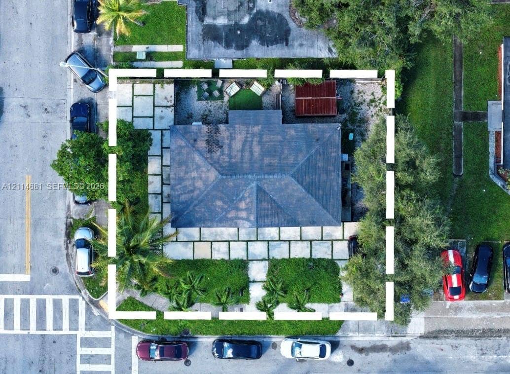 6700 NW 5th Avenue, Miami, FL 33150 Aerial perspective featuring a hip roof, large-format concrete paver hardscaping, mature landscaping, and peripheral fencing