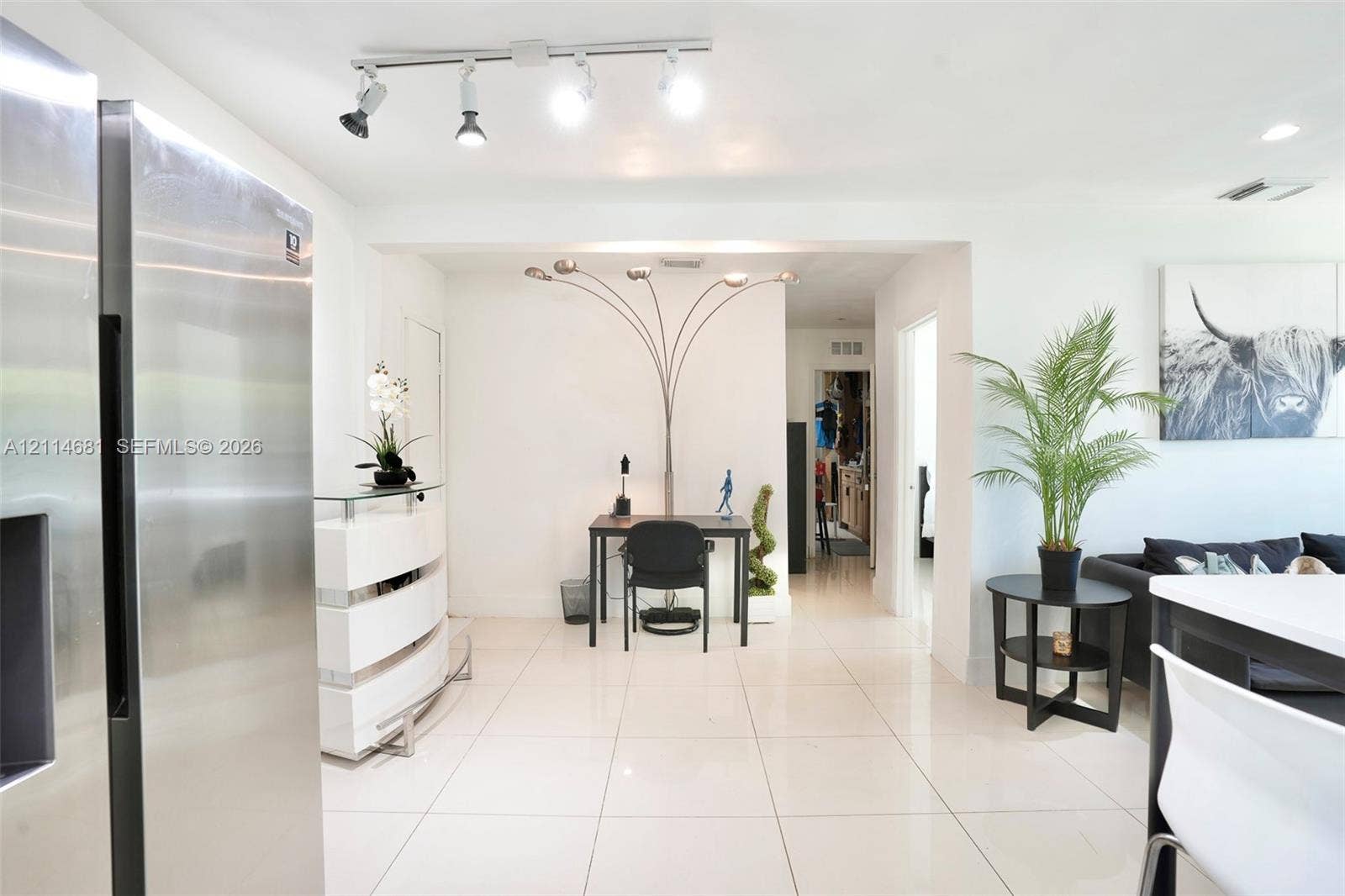 6700 NW 5th Avenue, Miami, FL 33150 Interior space featuring large-format ceramic tile flooring, stainless steel refrigerator, and adjustable multi-directional track lighting