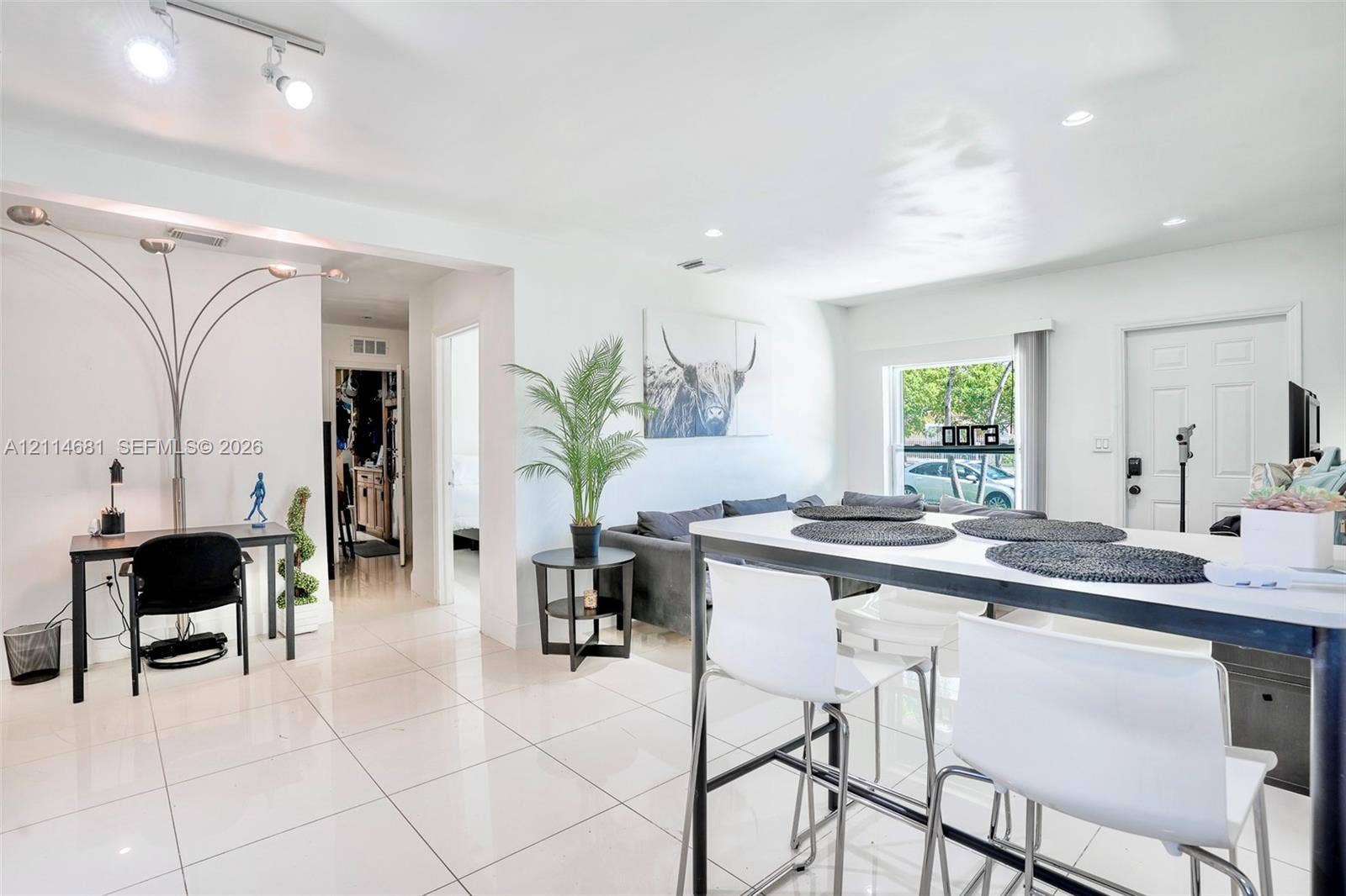 6700 NW 5th Avenue, Miami, FL 33150 Open-concept living space featuring high-gloss tile flooring and recessed ceiling lighting