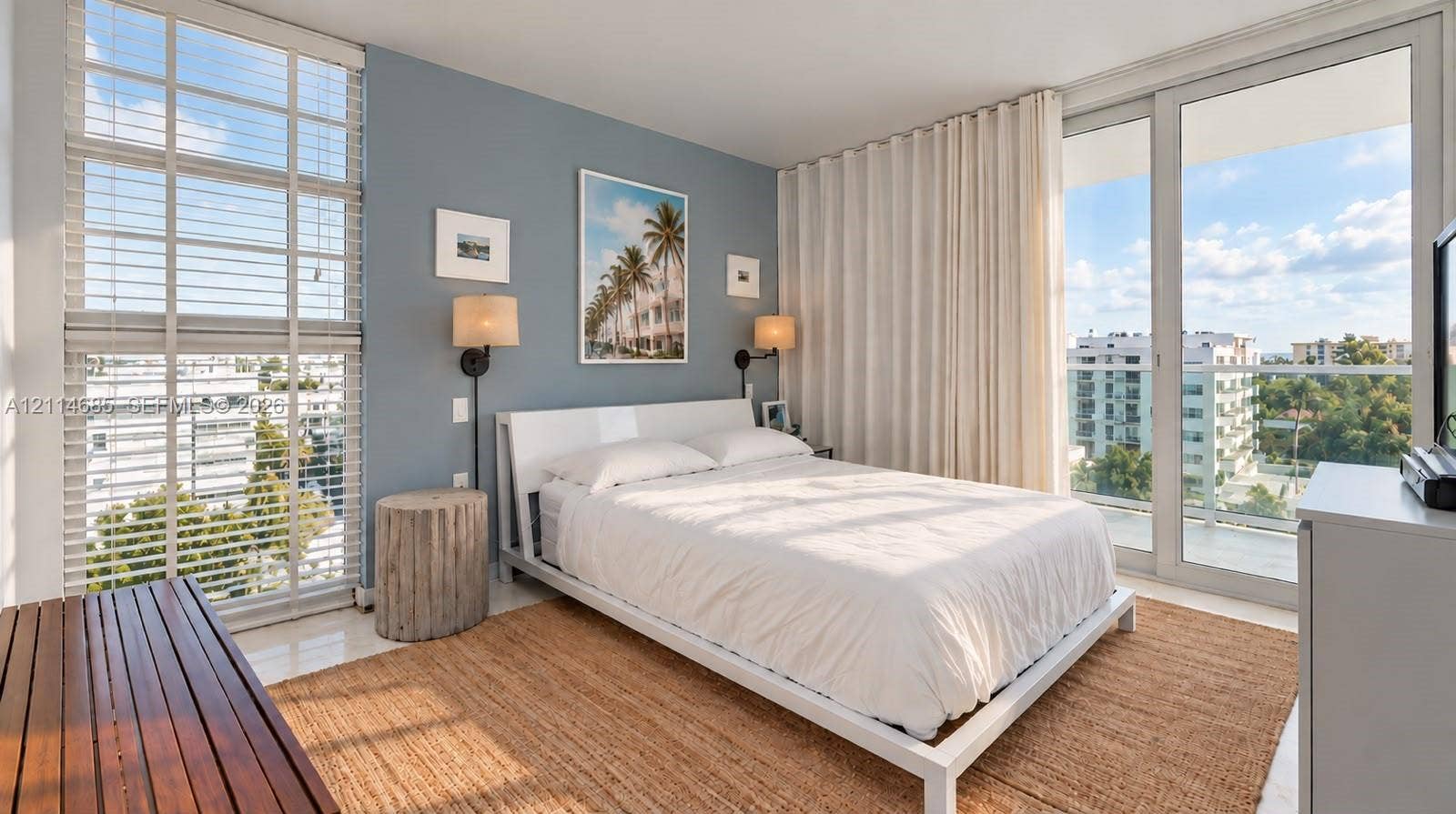 1035 West Avenue, #704, Miami Beach, FL 33139 Floor-to-ceiling windows, sliding glass door with balcony access, and wall-mounted light fixtures
