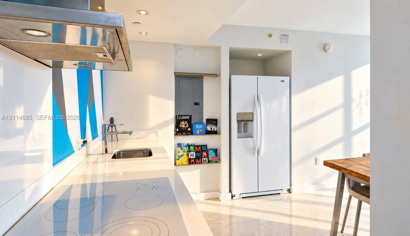 1035 West Avenue, #704, Miami Beach, FL 33139 Kitchen featuring a smooth-top electric cooktop, stainless steel range hood, stone-finish countertops, integrated sink, and white side-by-side refrigerator