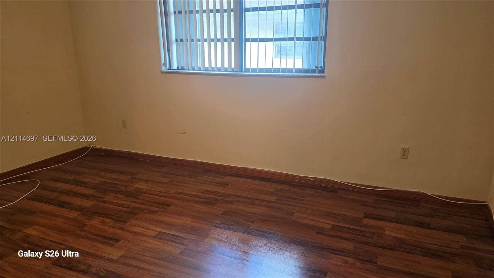 121 SW 113th Avenue, #104-10, Sweetwater, Sweetwater, FL 33174 Room featuring wood-finish flooring and a window with vertical blinds