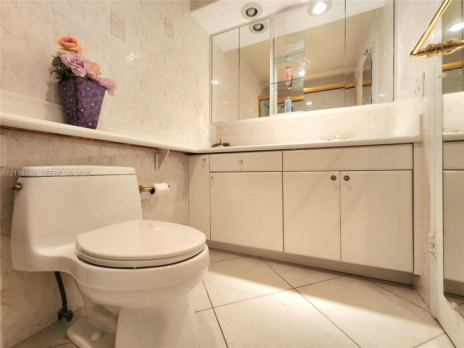 3505 S Ocean Drive, #705, Hollywood, Hollywood, FL 33019 Bathroom vanity featuring white cabinetry, a solid-surface countertop, and an integrated tri-fold medicine cabinet with recessed lighting