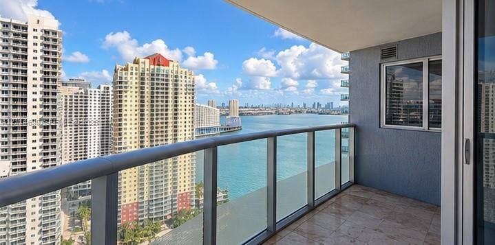 1300 Brickell Bay Drive, #3007, Miami, FL 33131 Covered balcony featuring tile flooring and a glass-paneled metal railing