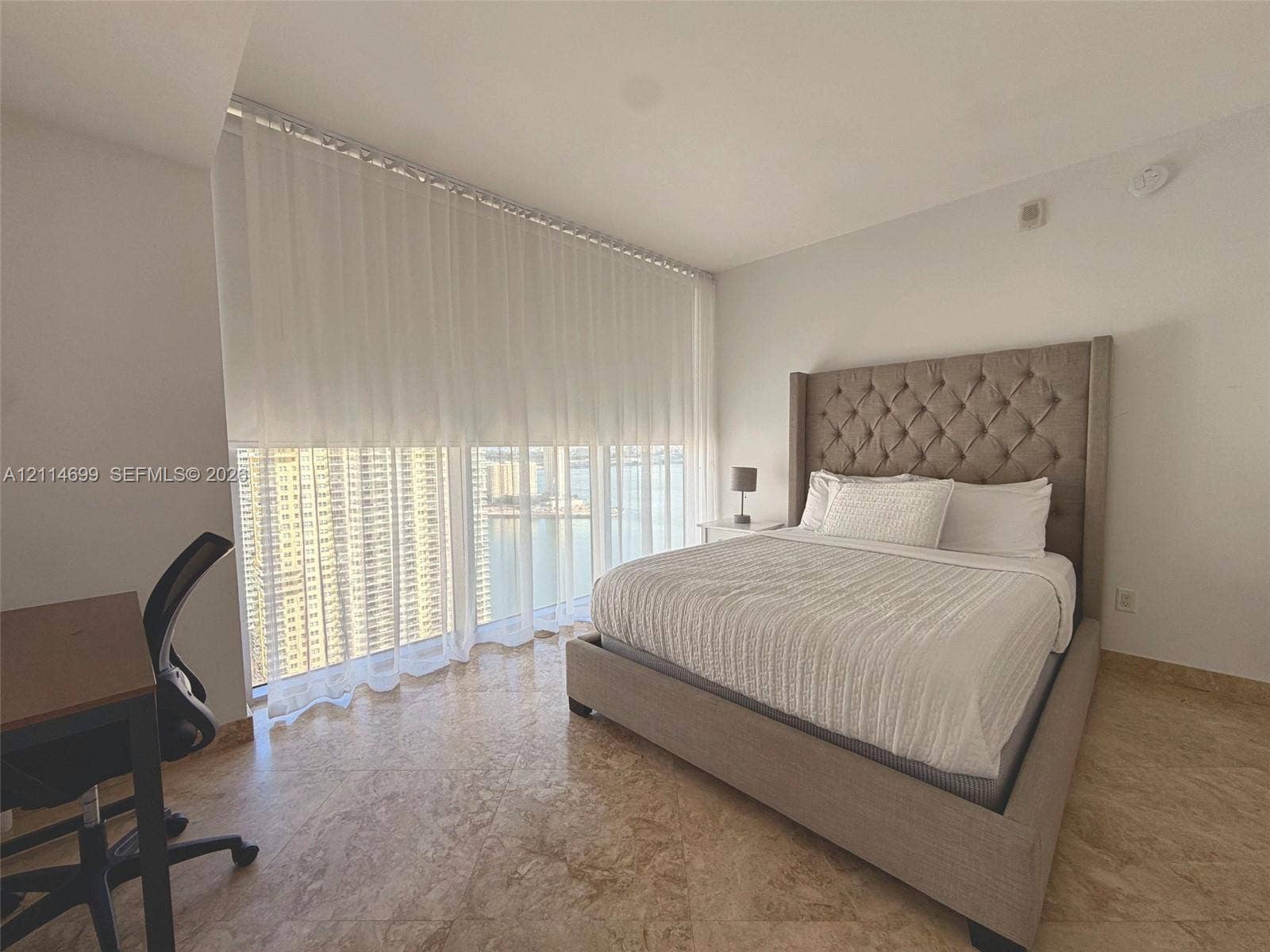 1300 Brickell Bay Drive, #3007, Miami, FL 33131 Floor-to-ceiling windows featuring urban scenery and polished stone flooring