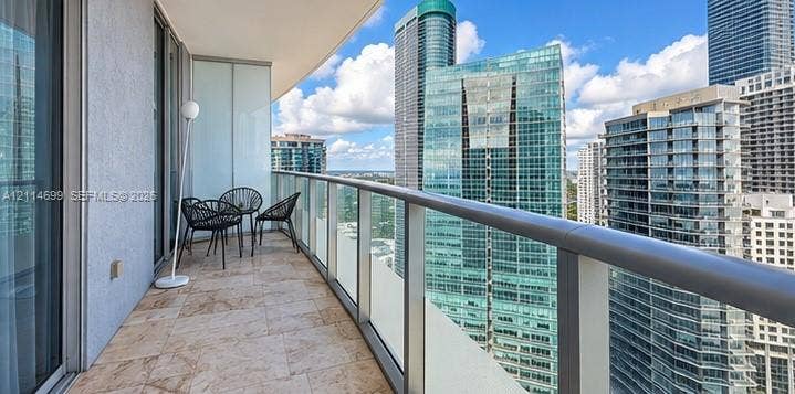 1300 Brickell Bay Drive, #3007, Miami, FL 33131 Private balcony featuring stone tile flooring and a glass panel railing