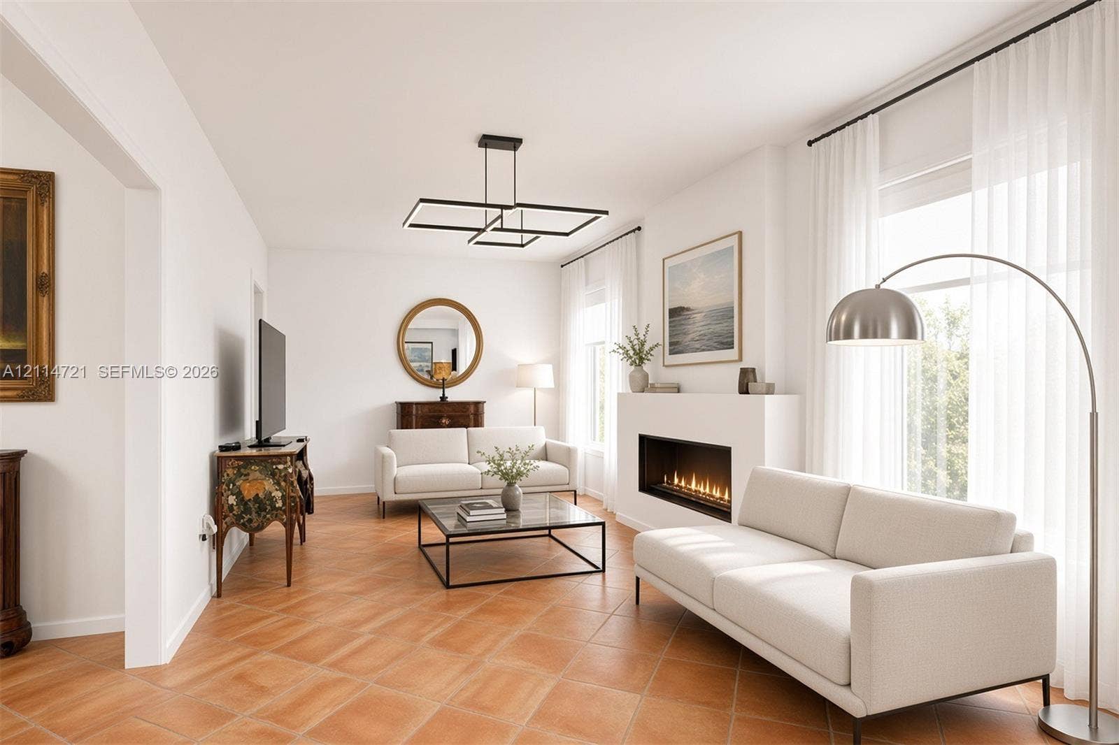 Living area featuring terra-cotta tile flooring, a linear built-in fireplace, and a geometric multi-tier chandelier