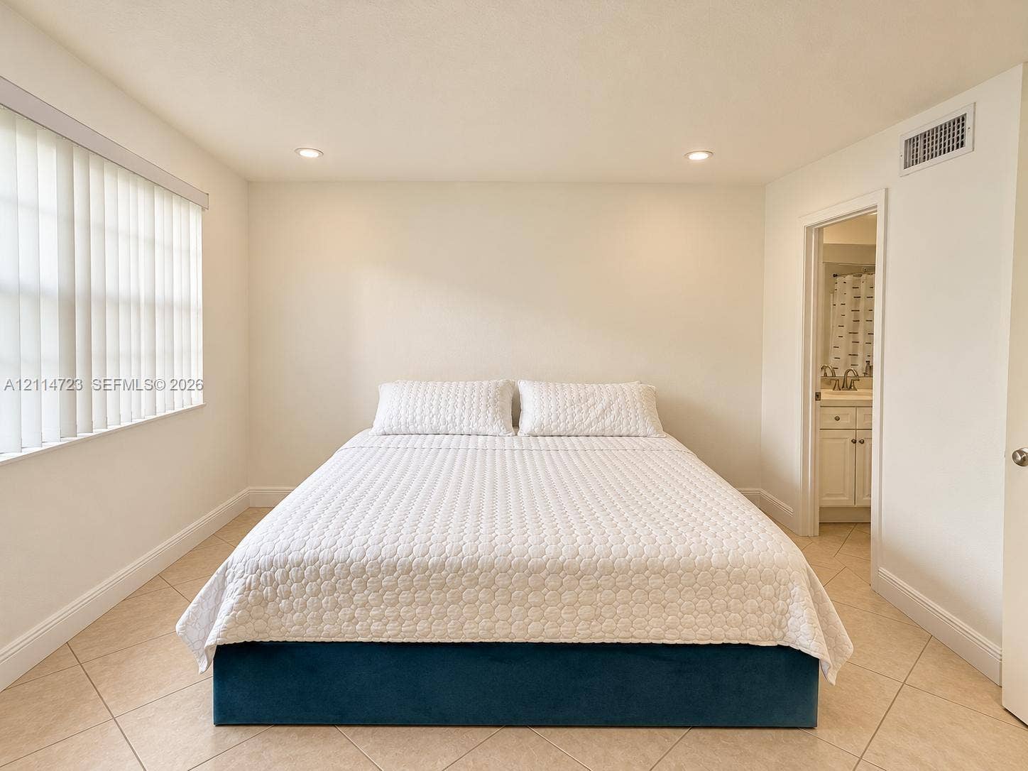 Room featuring diagonal ceramic tile flooring, recessed lighting, and vertical window blinds