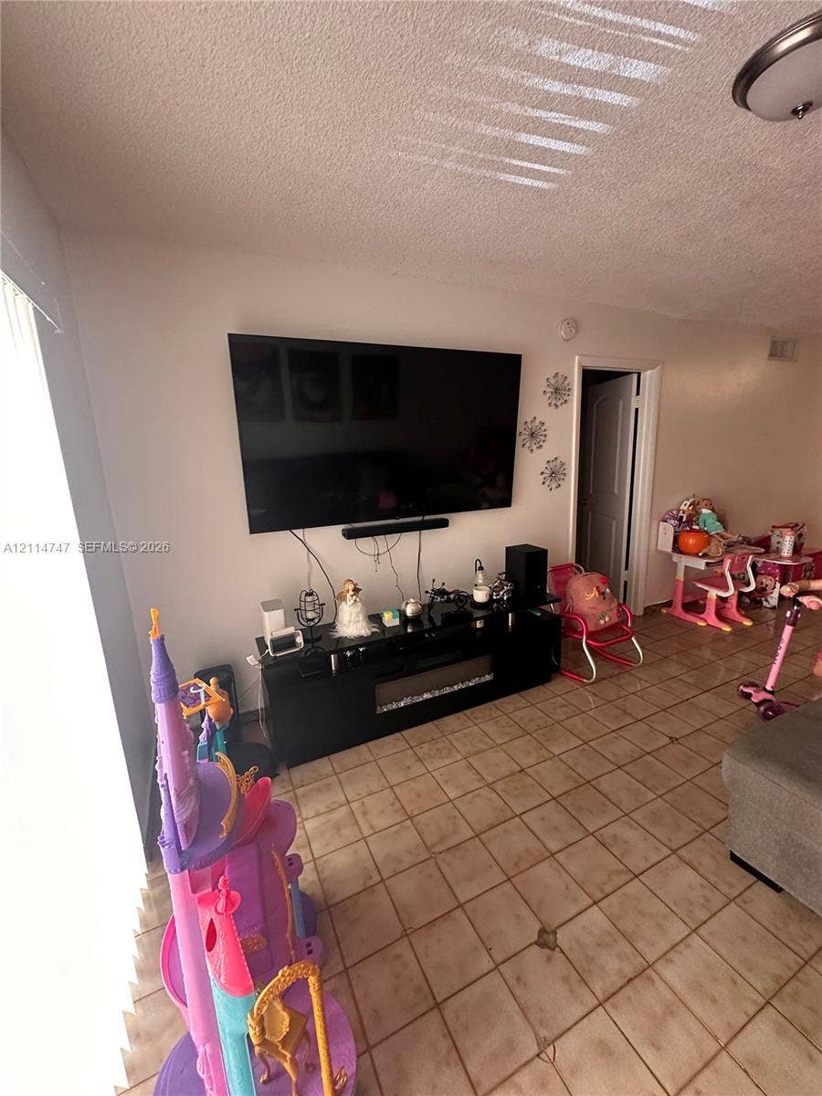1285 W 26th Place, #202, Hialeah, Hialeah, FL 33010 Ceramic tile flooring throughout with a flush-mount ceiling fixture and a paneled interior door