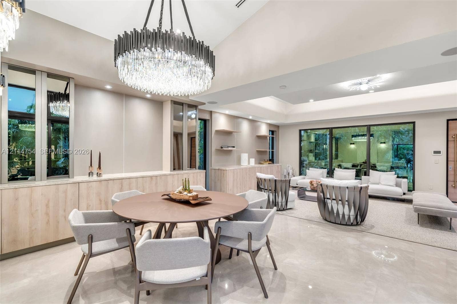 6731 SW 64th Avenue, South Miami, FL 33143 Covered outdoor kitchen featuring stainless steel cabinetry, a professional-grade grill, and a matching range hood, complete with natural stone flooring and a pool