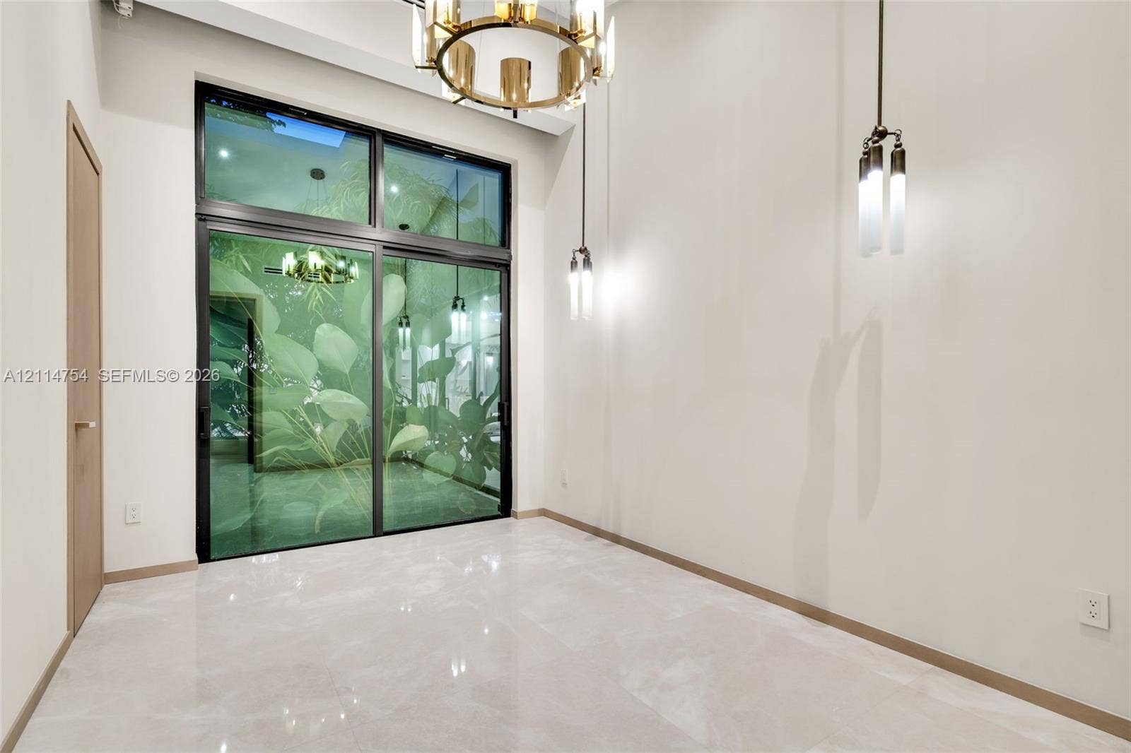 6731 SW 64th Avenue, South Miami, FL 33143 Vaulted ceilings featuring multi-pendant spherical lighting, light-toned wood-finish interior doors, and large-format neutral tile flooring